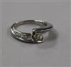 A modern 18ct white gold and fancy set single stone diamond ring with diamond set shoulders, size N.                                   