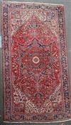 A Heriz red ground rug, 15ft 4in by 11ft 5in.                                                                                          