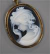 A yellow metal mounted sardonyx cameo pendant brooch, carved with the bust of a young lady to dexter, 50mm.                            