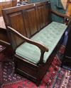 A mid 18th century oak box seat settle W.153cm                                                                                         