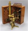 A Victorian brass scientific microscope by Ross, London, boxed with a case of slides                                                   