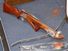 A hardwood and stainless steel crossbow and bolts                                                                                      