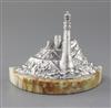 A modern silver miniature model of a lighthouse in a rocky coastline by J.A. Campbell, width 18.6cm.                                   