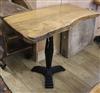 An oak top rustic table with a cast iron base W.99cm                                                                                   