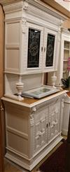 A late 19th century painted oak cabinet, with stained glass doors, W.110cm                                                             