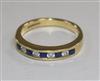 A modern 18ct gold and nine stone sapphire and diamond half hoop ring, size N.                                                         