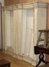 A pair of large white painted open library bookcases W.119cm                                                                           