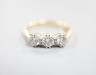 A modern 18ct gold and three stone diamond set ring, size J, gross weight 3 grams.                                                                                                                                          