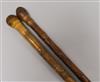 Two Oriental carved walking sticks Longest 90cm.                                                                                       