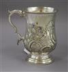 A white metal embossed engraved baluster mug, unmarked,                                                                                