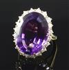 An 18ct gold, amethyst and diamond oval cluster ring, size K.                                                                          