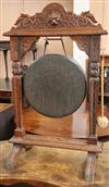 A late 19th century Flemish carved oak dinner gong, with striker H.100cm                                                               