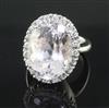 An 18ct white gold, kunzite and diamond oval cluster dress ring, size L.                                                               