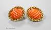 A modern pair of 18ct gold and fluted oval coral bead set earrings, 20mm, gross weight 12 grams.                                                                                                                            