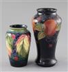 A Moorcroft 'pomegranate' vase and a 'leaf and berry' vase, 1930's, 17.5cm and 12.3cm, first vase with a chip to foot                  