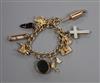 A 9ct gold charm bracelet, hung with ten assorted charms including a chalcedony set mourning locket.                                   