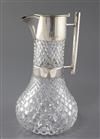 A late Victorian silver mounted cut glass claret jug by Hukin & Heath, in the manner of Christopher Dresser, 26cm.                     