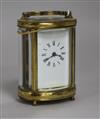 A late 19th century French oval brass cased miniature eight day carriage timepiece height 22cm                                         