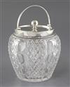 An Edwardian silver mounted cut glass biscuit barrel and cover, by John Grinsell & Sons, 15.5cm.                                       