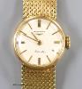 A lady's 9ct gold Longines manual wind wrist watch, on a 9ct gold bracelet, case diameter 20mm, gross weight 31.1 grams, in Longines box.                                                                                   