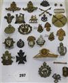 A collection of twenty five assorted cap and other uniform badges and two small buttons                                                