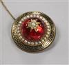 A Victorian yellow metal, enamel, split pearl and red paste? target mourning brooch, 40mm.                                             
