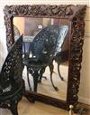 A carved oak framed mirror W.83cm                                                                                                      