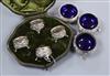 A set of three Victorian embossed silver cauldron salts with blue glass liners and a set of four cased silver salts                    