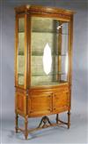 An Edwardian satinwood bowfront display cabinet, W.3ft 6in. D.1ft 8in. H.7ft 3in.                                                      