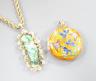 A 14k yellow metal and carved jade set pendant, 45mm, gross 8.5 grams, on a 9ct gold ropetwist chain, 56cm, 10.5 grams and an enamelled gilt white metal pendant.                                                           