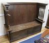 An Arts & Crafts oak settle W.159cm                                                                                                    