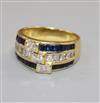 A modern 18ct gold and triple row sapphire and diamond channel set dress ring,                                                         