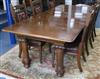 An extending dining table with four leaves W.265cm                                                                                     