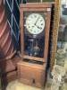 An early 20th century oak cased clocking in clock, height 116cm                                                                                                                                                             