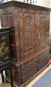 A large carved oak cupboard W.140cm                                                                                                    