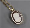 A 9ct gold gold oval "cameo" pendant brooch, on a 9ct gold chain, brooch 24mm.                                                         