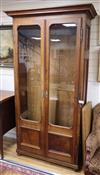 A 19th century Continental walnut glazed bookcase H.226cm                                                                              