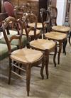 A set of six 19th century French stained beech rush seated dining chairs                                                               