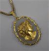 A yellow metal and diamond set chalcedony "cameo" style oval pendant, with a 9ct gold chain, pendant 54mm.                             