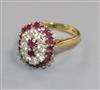 An 18ct gold, ruby and diamond cluster dress ring, size M/N.                                                                           