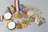 A 1562 shilling and other assorted coinage, two pocket watches and a group of mixed medals including a WWI trio.                                                                                                            