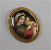 A yellow metal mounted oval plaque brooch, decorated with "Virgin & Child", 41mm.                                                      