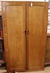 A panelled oak wardrobe and a matching night stand (reputed to be the work of John Skelton) Wardrobe W.107cm                           