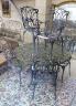 A painted aluminium circular garden table, diameter 124cm, height 73cm and six aluminium garden elbow chairs                                                                                                                