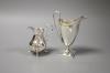 A George III silver helmet cream jug, London 1791 and another cream jug of bellied form,                                                                                                                                    