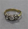 An 18ct gold and three stone diamond ring, size N.                                                                                     