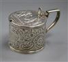 A George III silver mustard pot with later? embossed decoration.                                                                       