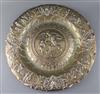 A large embossed white metal charger,                                                                                                  