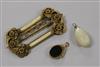 An ornate gilt metal buckle and 9ct gold mounted fob and a pendant.                                                                    