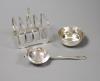 A silver four-division toast rack, a tea strainer and a drip tray,                                                                                                                                                          